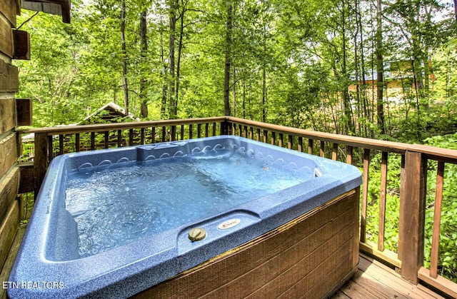 wooden deck with a hot tub