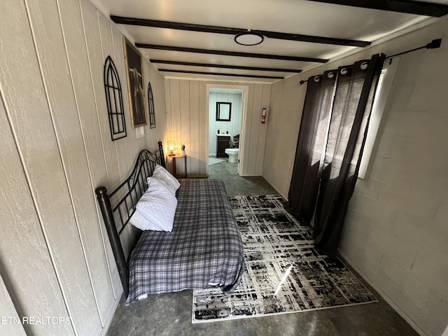 hallway featuring beamed ceiling and wood walls