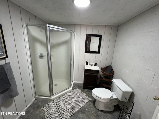 bathroom featuring concrete flooring, vanity, toilet, and a shower with shower door