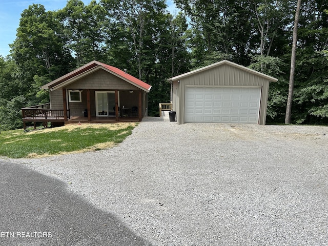 single story home featuring a deck and a garage