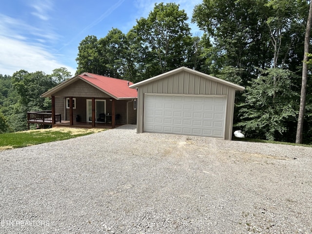 ranch-style house featuring a garage and an outbuilding