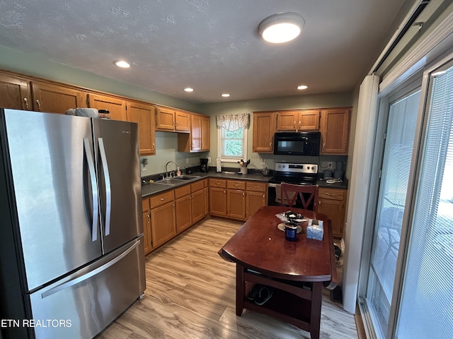 kitchen featuring sink, stainless steel appliances, and light hardwood / wood-style flooring