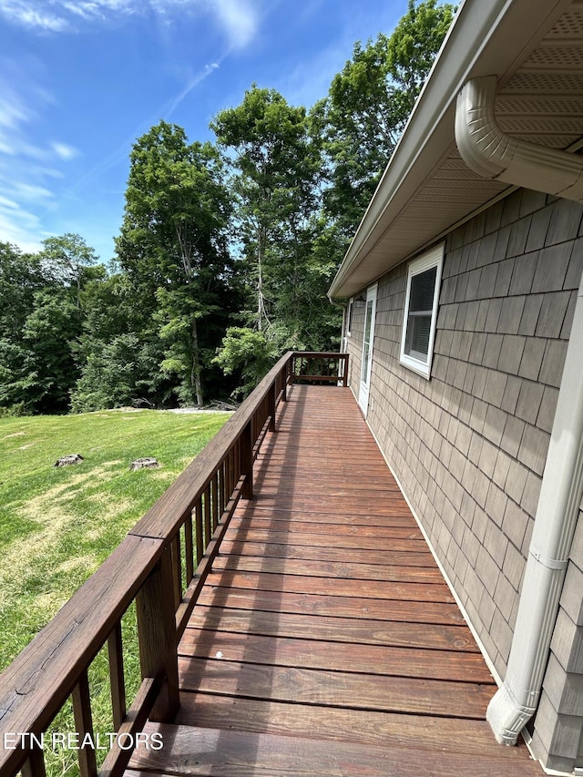 wooden deck featuring a yard