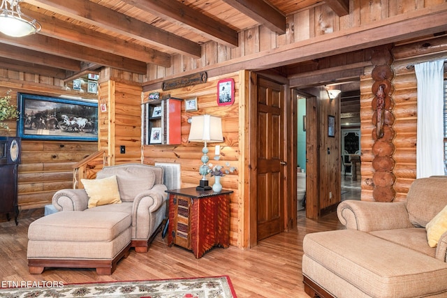 sitting room featuring beam ceiling, wood ceiling, rustic walls, and hardwood / wood-style flooring