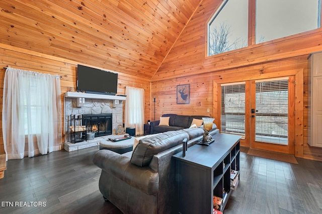 living room featuring a fireplace, dark hardwood / wood-style flooring, high vaulted ceiling, and french doors