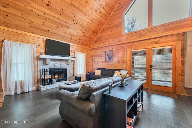 living room with a stone fireplace, french doors, high vaulted ceiling, and dark hardwood / wood-style floors