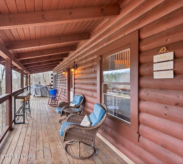 wooden terrace featuring covered porch