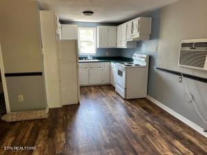 kitchen featuring white cabinets, white appliances, and dark hardwood / wood-style flooring