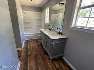 bathroom with vanity, hardwood / wood-style floors, and shower / bathing tub combination