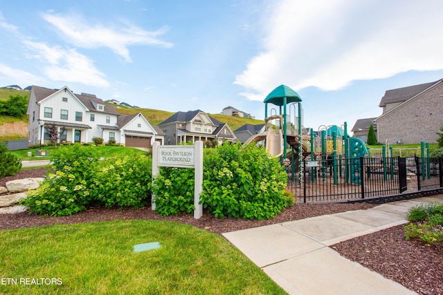 communal playground with a residential view and fence