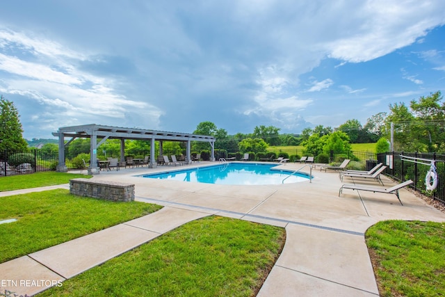 pool with a patio area, a lawn, a pergola, and fence