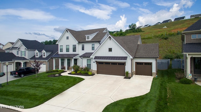 modern farmhouse style home featuring board and batten siding, a shingled roof, metal roof, an attached garage, and a standing seam roof