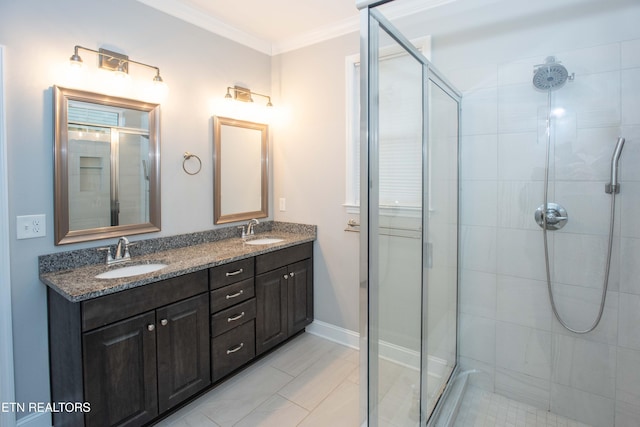 bathroom featuring a sink, a stall shower, and ornamental molding