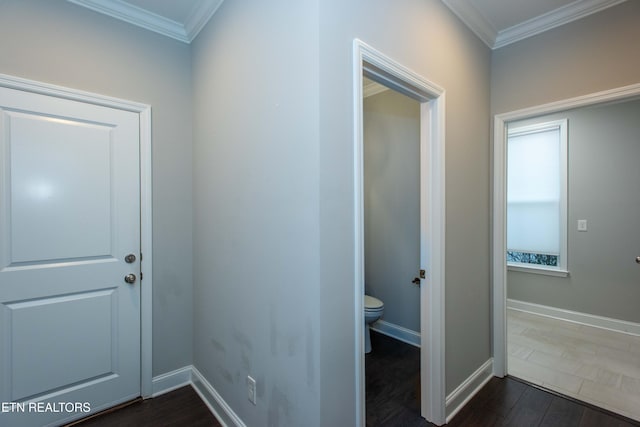 hall with crown molding, dark wood-style floors, and baseboards