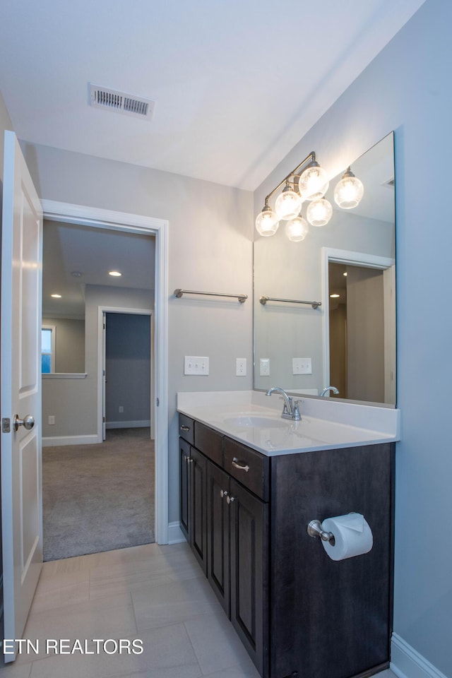 bathroom featuring vanity, baseboards, and visible vents