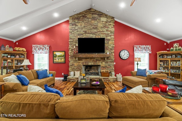 living room with a fireplace, wood-type flooring, vaulted ceiling, and ornamental molding