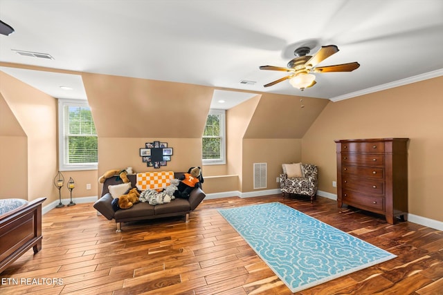 interior space featuring hardwood / wood-style floors, ceiling fan, lofted ceiling, and ornamental molding