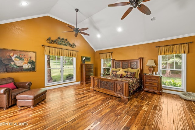 bedroom with hardwood / wood-style flooring, vaulted ceiling, and multiple windows