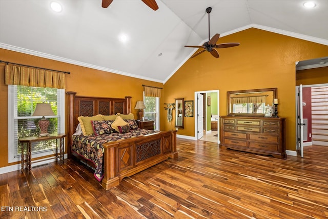 bedroom with dark hardwood / wood-style flooring, vaulted ceiling, ceiling fan, crown molding, and connected bathroom