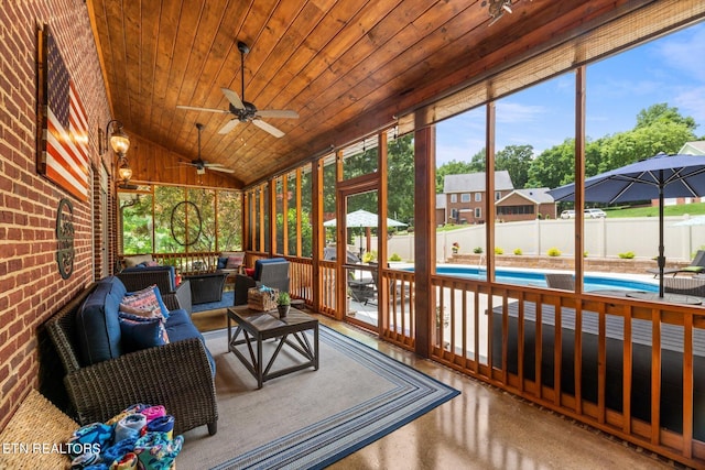 sunroom / solarium featuring ceiling fan, wooden ceiling, a wealth of natural light, and vaulted ceiling