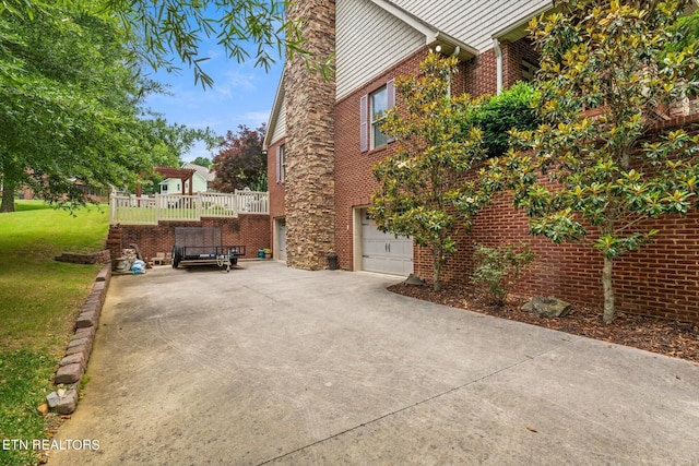 view of side of home with a garage and a yard