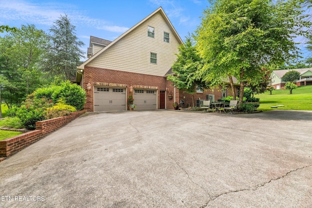 view of home's exterior featuring a yard and a garage