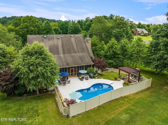 view of pool featuring a lawn, a pergola, and a patio