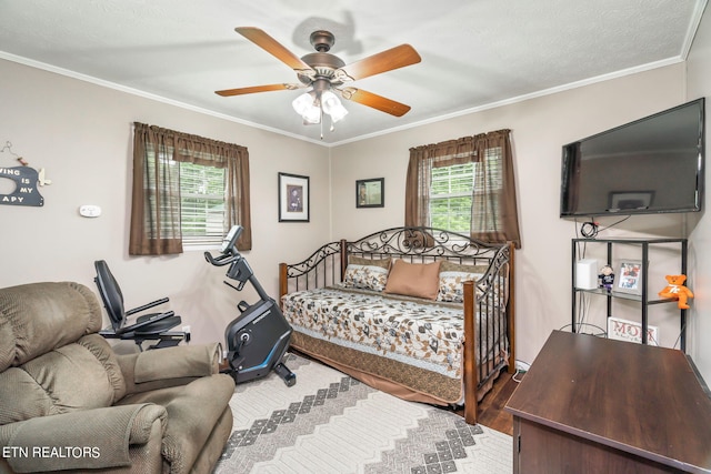 bedroom featuring hardwood / wood-style flooring, multiple windows, crown molding, and ceiling fan