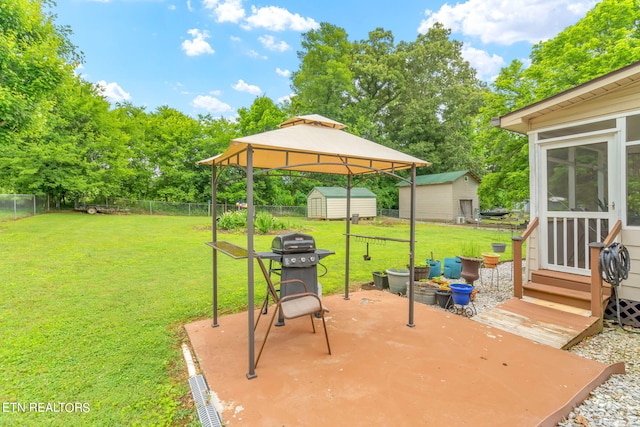 view of patio / terrace featuring a gazebo, area for grilling, and a shed