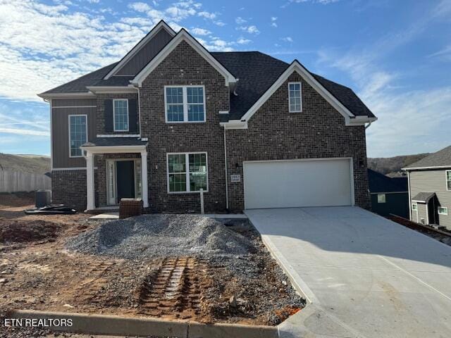 view of front of home with cooling unit and a garage