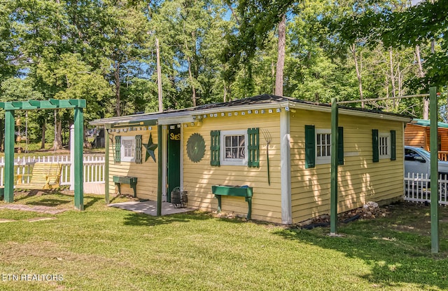 view of front facade with an outbuilding and a front lawn