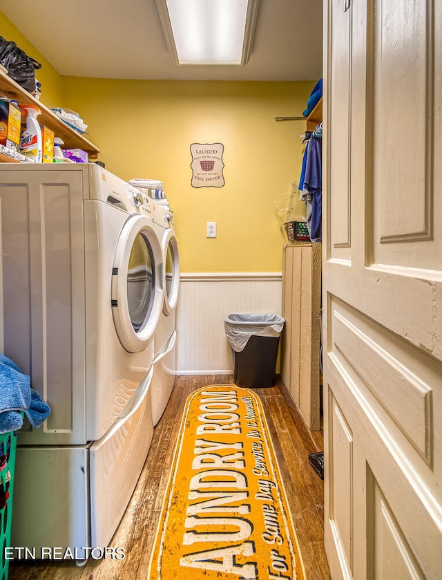 laundry area with independent washer and dryer and dark hardwood / wood-style floors