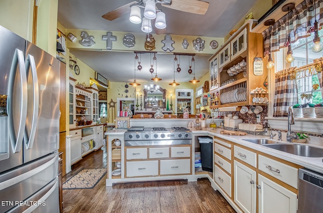 kitchen featuring white cabinetry, sink, stainless steel appliances, dark hardwood / wood-style floors, and pendant lighting