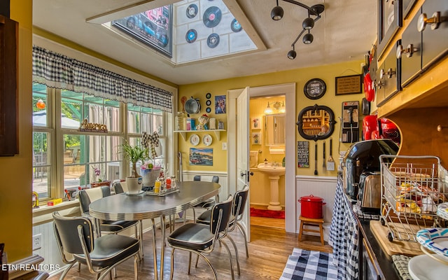 dining room featuring wood-type flooring and sink