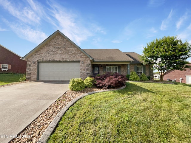 ranch-style house featuring a garage, a wall mounted AC, and a front lawn