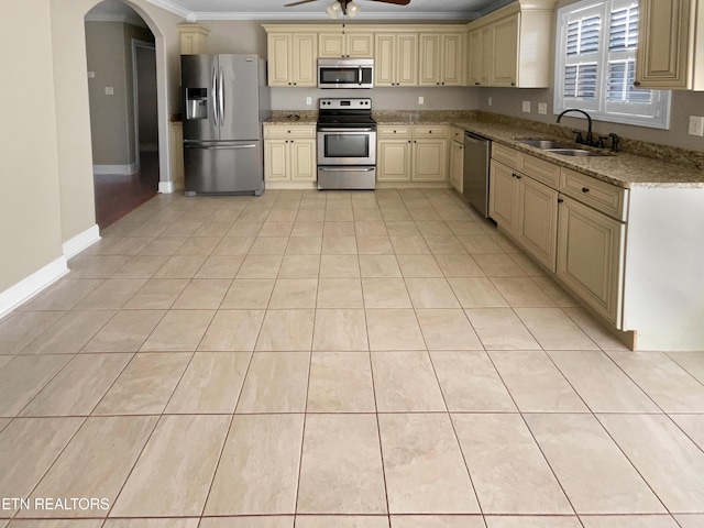 2113 Griffitts Mill Cir, Maryville, TN 37803 - kitchen featuring appliances with stainless steel finishes, cream cabinets, a sink, a ceiling fan, and ornamental molding