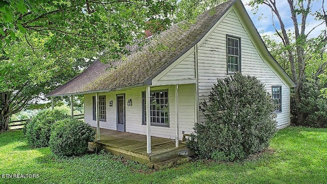 view of front of property with covered porch and a front yard