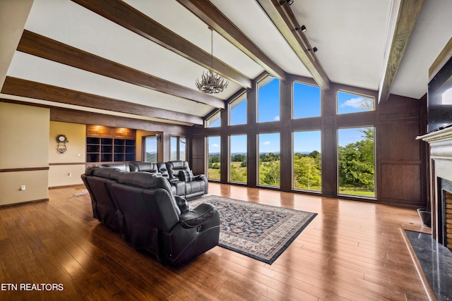 living room featuring a high end fireplace, wood-type flooring, and lofted ceiling with beams