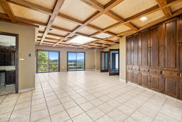 unfurnished living room featuring beam ceiling, coffered ceiling, and light tile patterned flooring