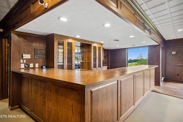 interior space featuring wood walls and light hardwood / wood-style floors