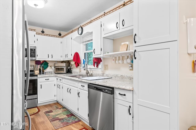 kitchen featuring sink, white cabinetry, and stainless steel appliances