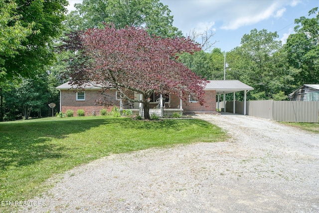 view of front facade featuring a front lawn and a carport