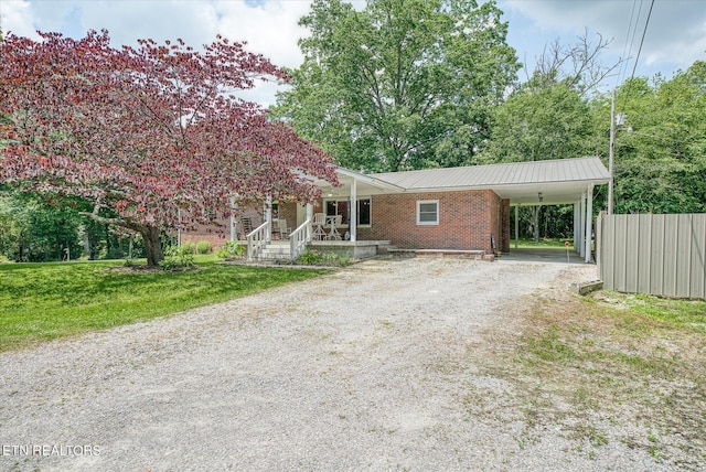 view of front of property with a carport and a front yard