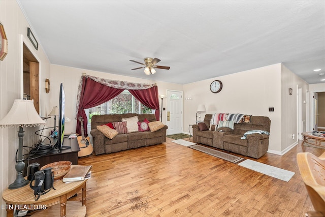 living room with ceiling fan and light wood-type flooring