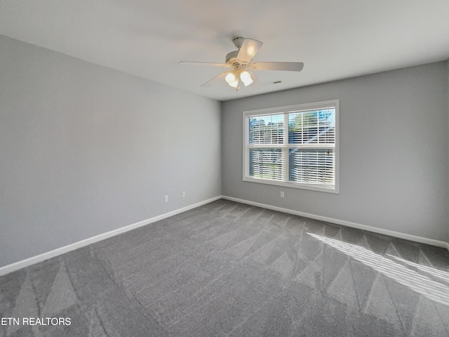 empty room with ceiling fan and carpet