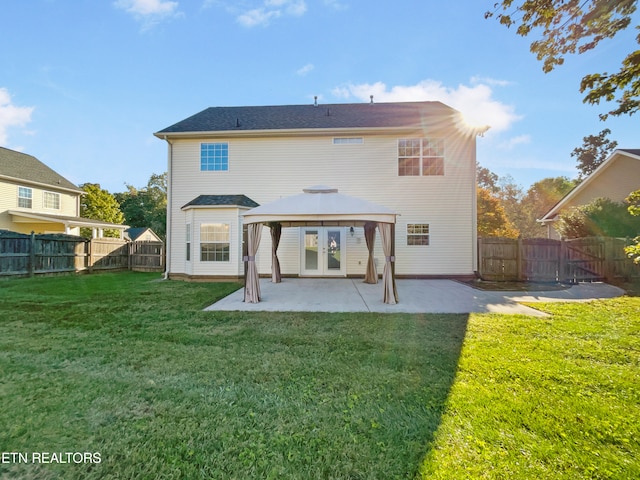 back of property with a gazebo, a yard, and a patio area