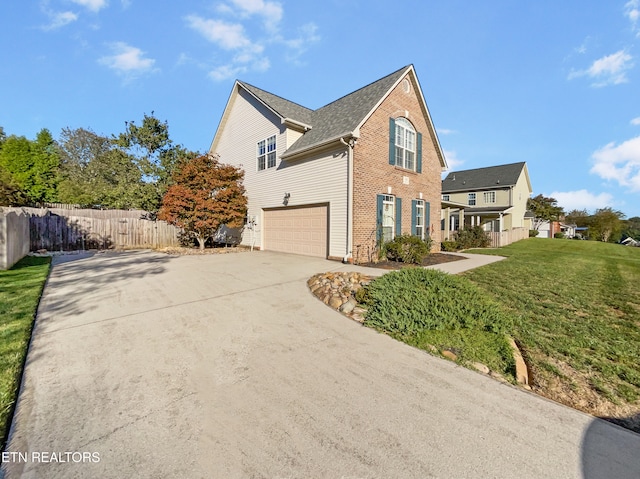 view of side of property featuring a yard and a garage