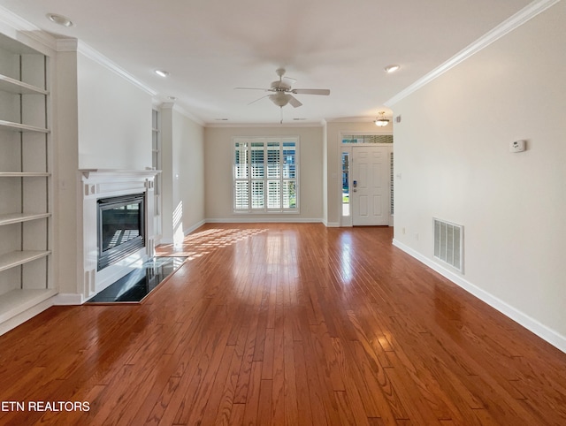 unfurnished living room with crown molding, hardwood / wood-style flooring, and ceiling fan