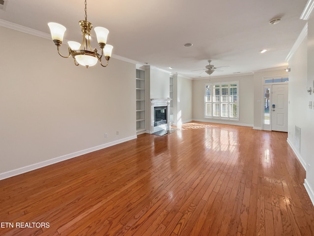 unfurnished living room with ornamental molding, wood-type flooring, and ceiling fan with notable chandelier