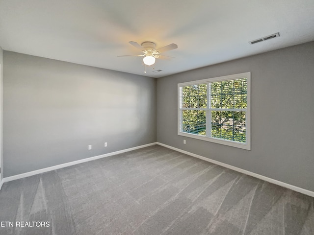 spare room with carpet floors and ceiling fan